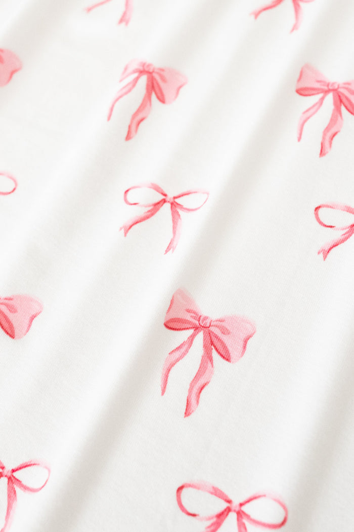 White fabric with pink bow pattern