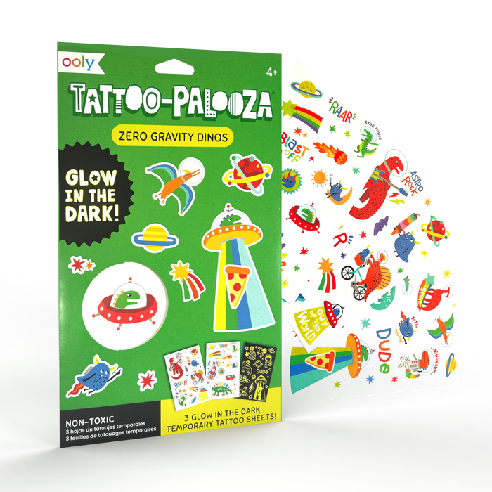 Angle of set and sheets fanned out of OOLY Tattoo-Palooza Glow in the Dark Temporary Tattoos - Zero Gravity Dinos