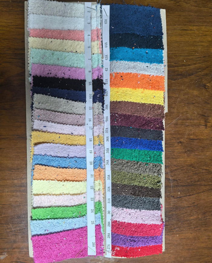 Colorful fabric swatches for a Terry cloth handbag from Travellers Hat Boutique in various vibrant shades