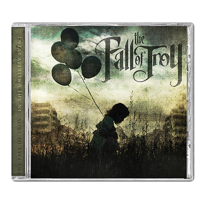 The CD cover for The Fall of Troy’s In the Unlikely Event Deluxe Edition features a child’s silhouette holding black balloons in a grassy field, with tall buildings, a cloudy sky, and the band’s logo at the top right.