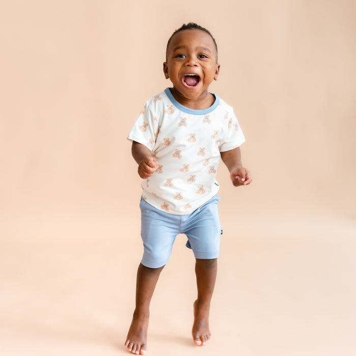 toddler boy jumping and smiling wearing  Toddler Basic Tee in Teddy Bear