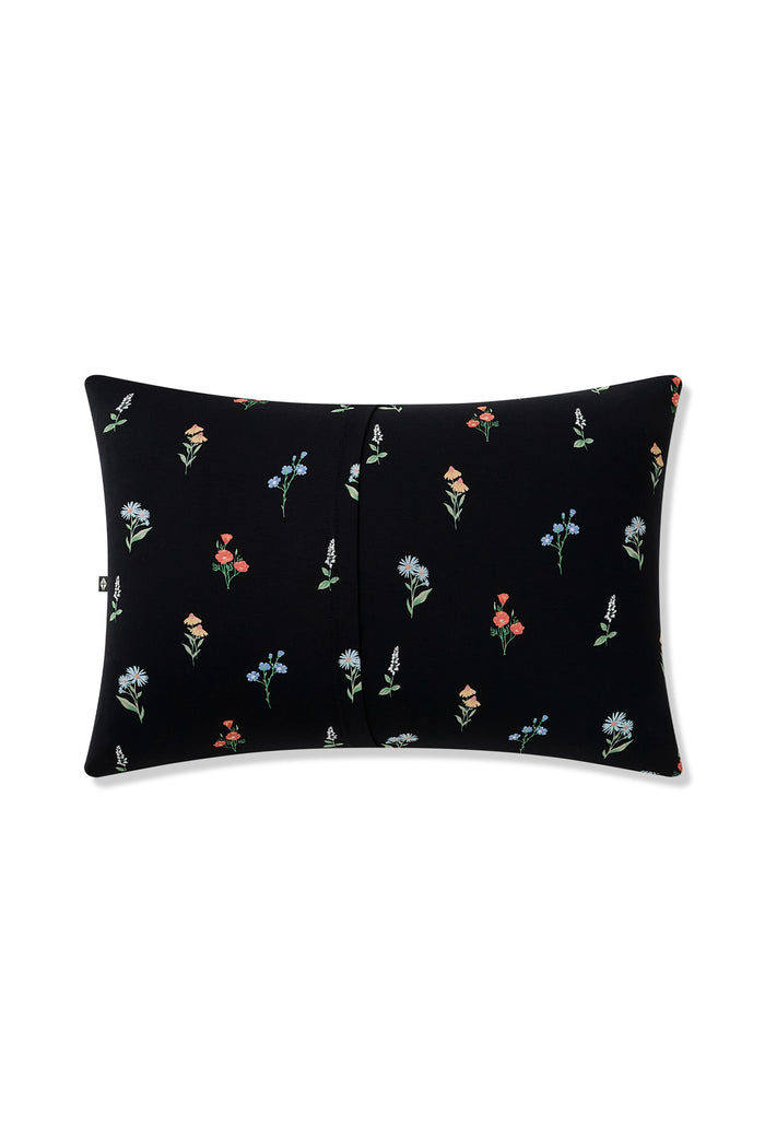 Back side of Black Toddler Pillowcase in Wildflower print on a white background