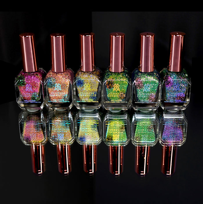 Set of six nail polish bottles containing Nail Lacquers from the Trip-Adelic Nail Lacquer Bundle, on a black background.