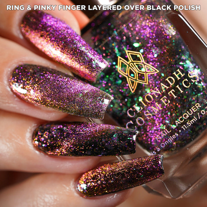 Close-up of nails painted with Pholiotina Nail Lacquer on fair skin tone. Hand is holding polish bottle.