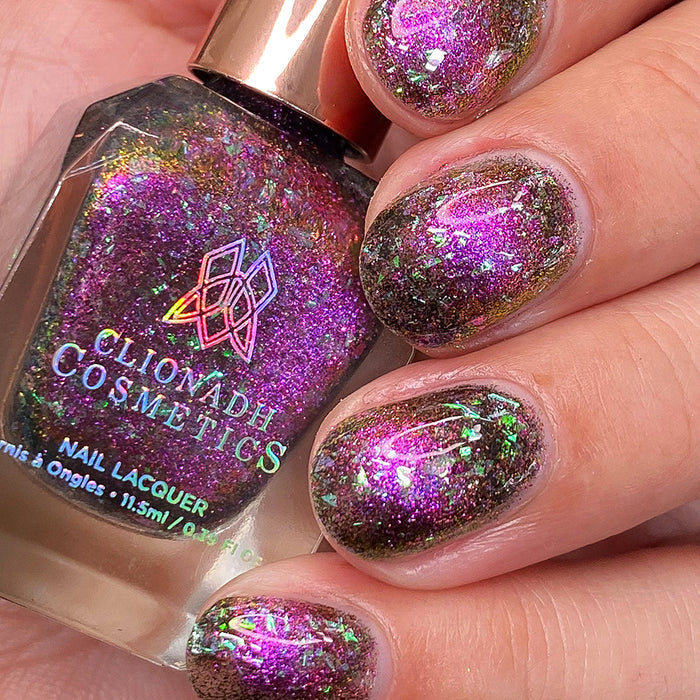 Close-up of nails painted with Pholiotina Nail Lacquer on fair skin tone. Hand is holding polish bottle.