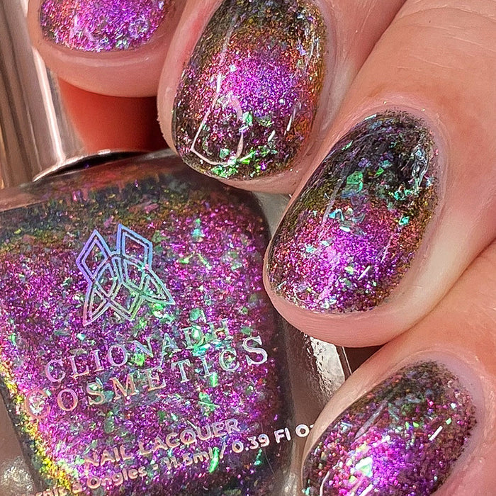 Close-up of nails painted with Pholiotina Nail Lacquer on fair skin tone. Hand is holding polish bottle.