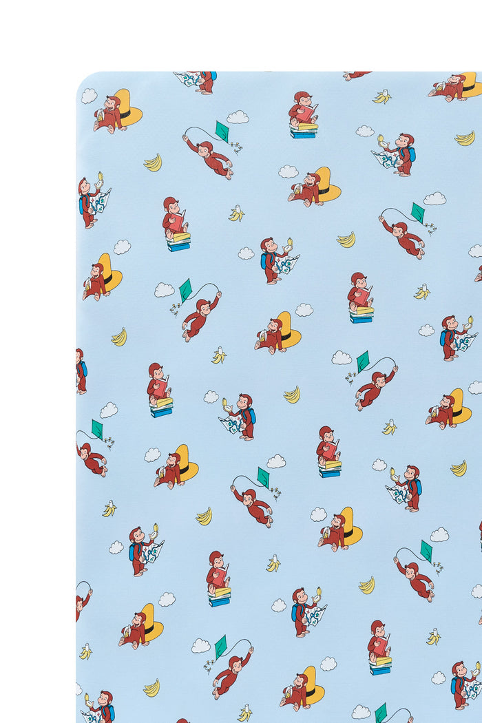 Close up of Blue Twin Sheet in Curious George print on a white background