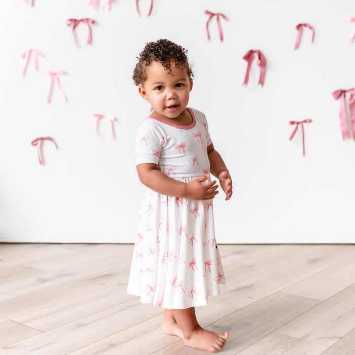 Little girl modeling Twirl Dress in Bow