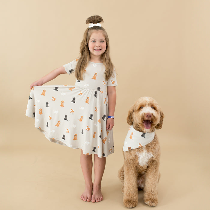 Child modeling Twirl Dress in Fluffy Dog with her dog wearing matching dog bandana