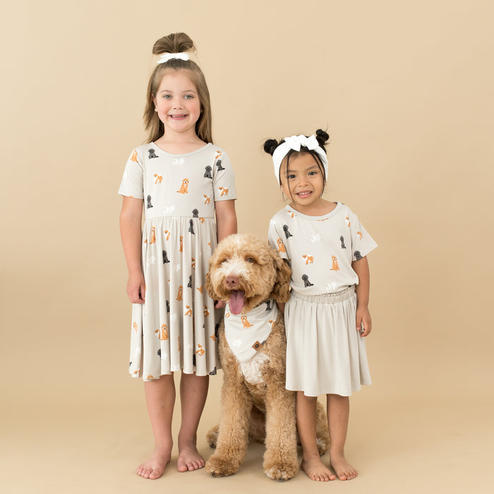 Two girls standing with a dog between them all matching in Fluffy Dog