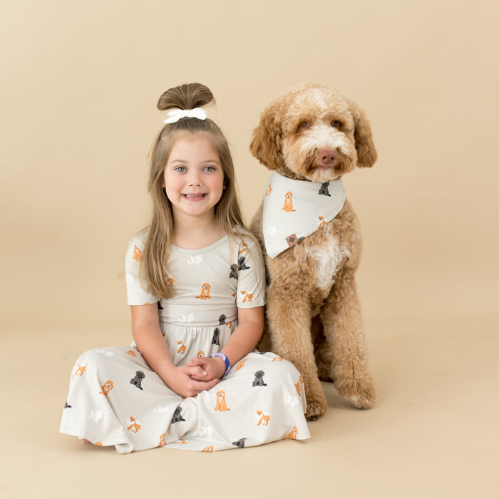 Child modeling Twirl Dress in Fluffy Dog sitting next to dog