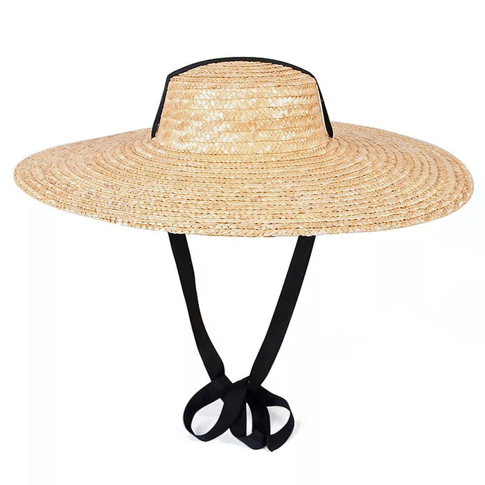 Wide brim wheat straw hat with ribbon ties perfect for sun protection and travel
