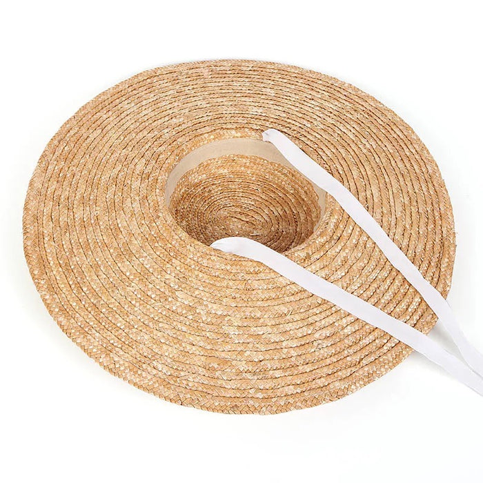 Wheat straw hat with ribbon in natural color featuring a wide brim for sun protection
