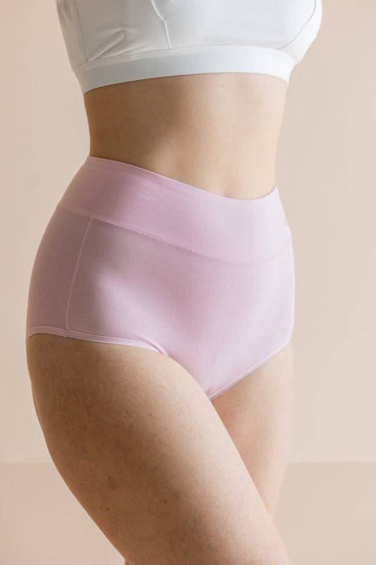 Light pink underwear worn by a person on a beige background