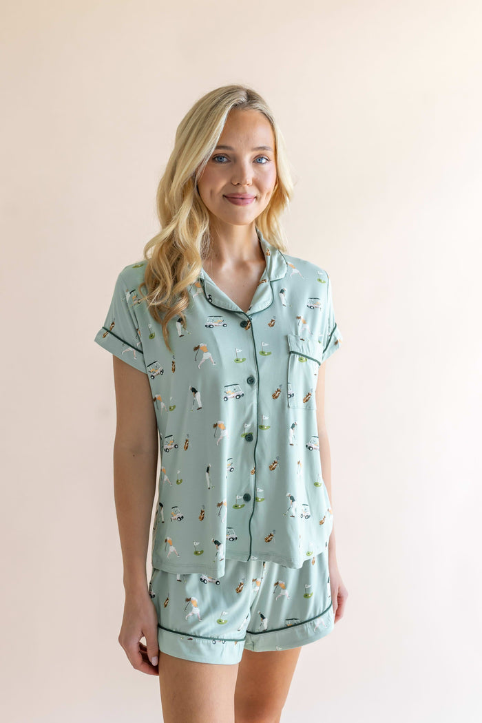 Model posing in Women's Short Sleeve Pajama Set in Golf print on beige background