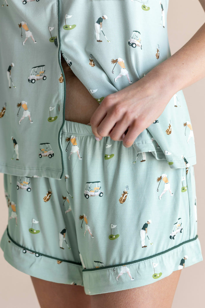 Model showcasing the shorts of  Women's Short Sleeve Pajama Set in Golf print on beige background