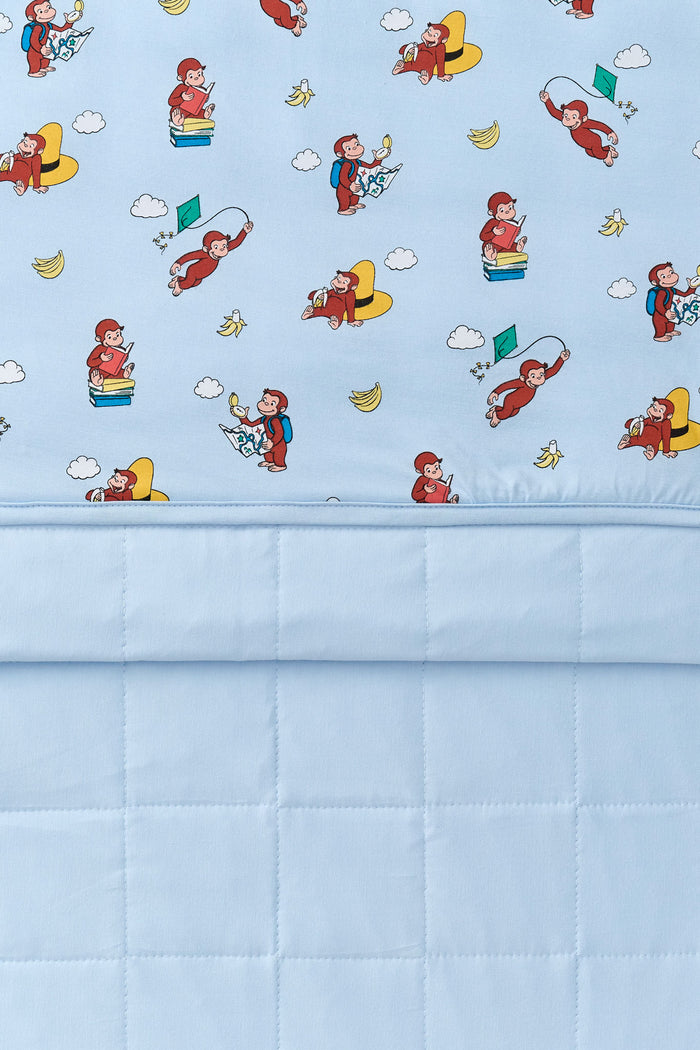 Front and back of Blue Youth Blanket in Curious George 2.5 print