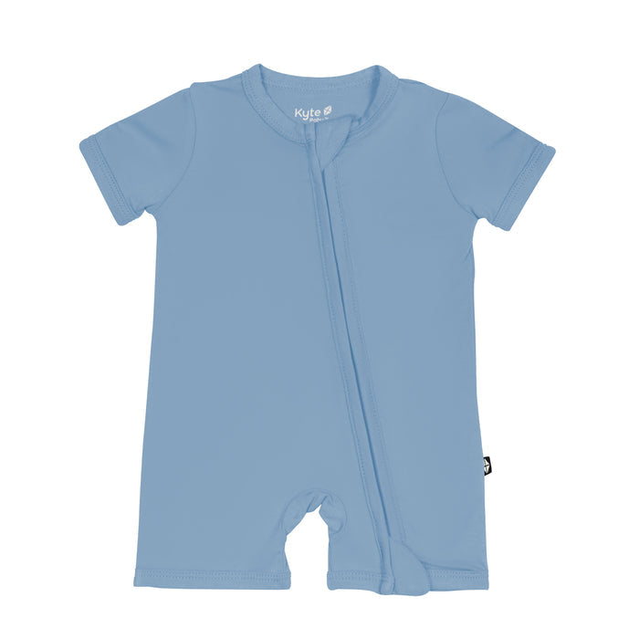 Flat lay of Kyte Baby Zippered Shortall Romper in Slate
